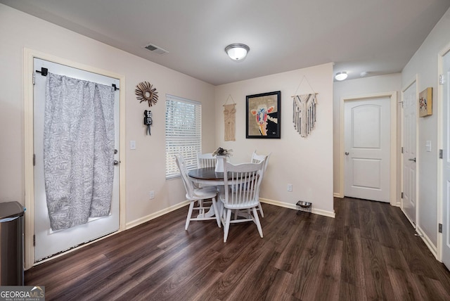 dining space featuring visible vents, baseboards, and wood finished floors