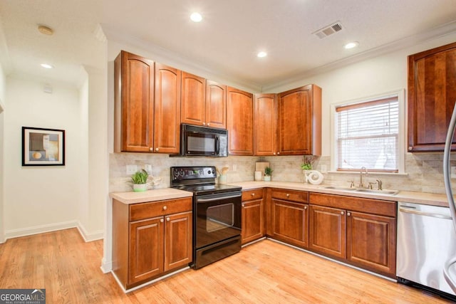 kitchen with black appliances, crown molding, sink, decorative backsplash, and light hardwood / wood-style floors