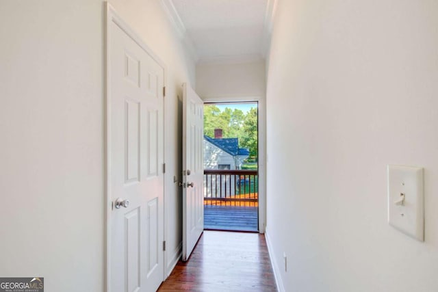 hallway with dark hardwood / wood-style flooring and ornamental molding