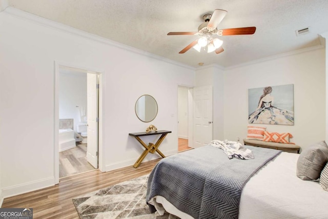 bedroom with ensuite bath, ceiling fan, crown molding, hardwood / wood-style floors, and a textured ceiling