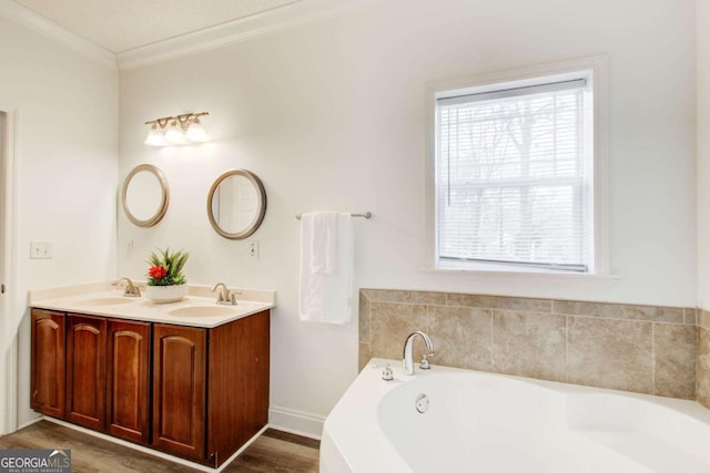 bathroom with a bathing tub, wood-type flooring, a wealth of natural light, and ornamental molding