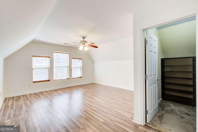 bonus room with ceiling fan, light hardwood / wood-style flooring, and vaulted ceiling