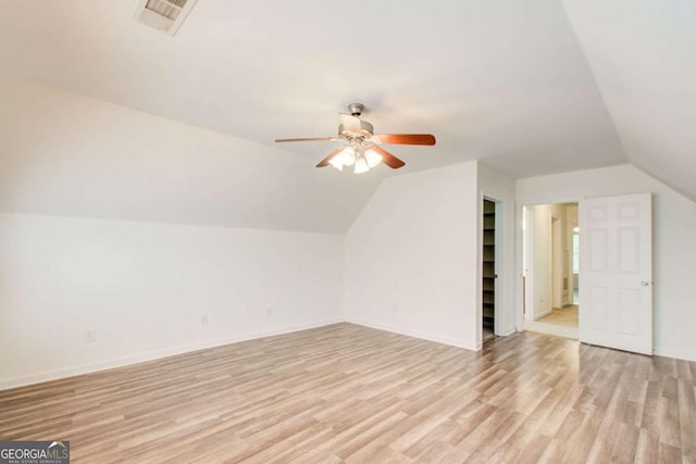 bonus room with ceiling fan, light hardwood / wood-style flooring, and vaulted ceiling