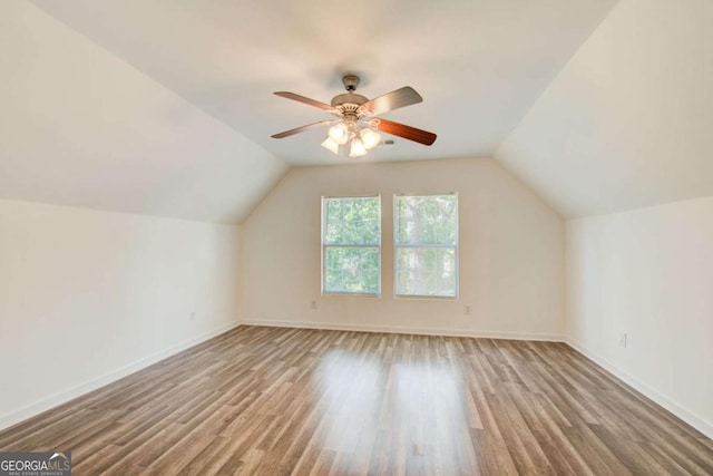 bonus room with ceiling fan, light hardwood / wood-style flooring, and vaulted ceiling