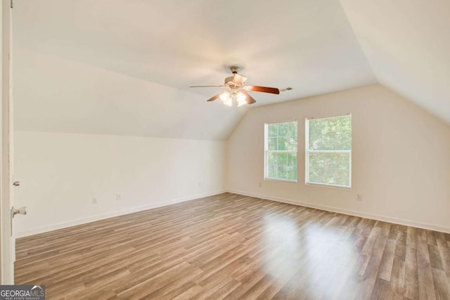 bonus room featuring ceiling fan, light hardwood / wood-style floors, and lofted ceiling