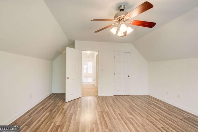 additional living space with ceiling fan, vaulted ceiling, and light wood-type flooring