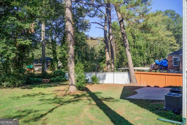 view of yard with central AC unit and a patio area