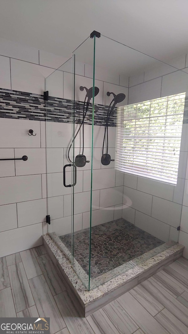 bathroom featuring a shower with shower door