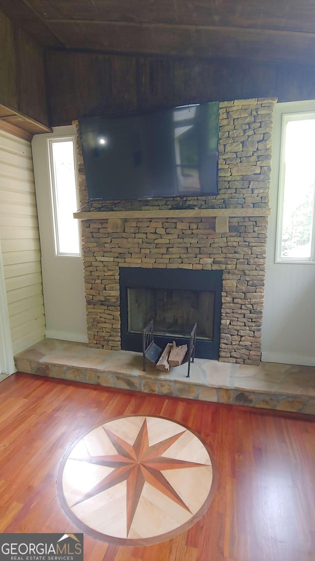 room details with hardwood / wood-style floors and a fireplace