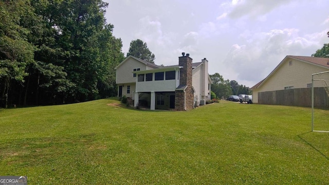 rear view of house featuring a yard