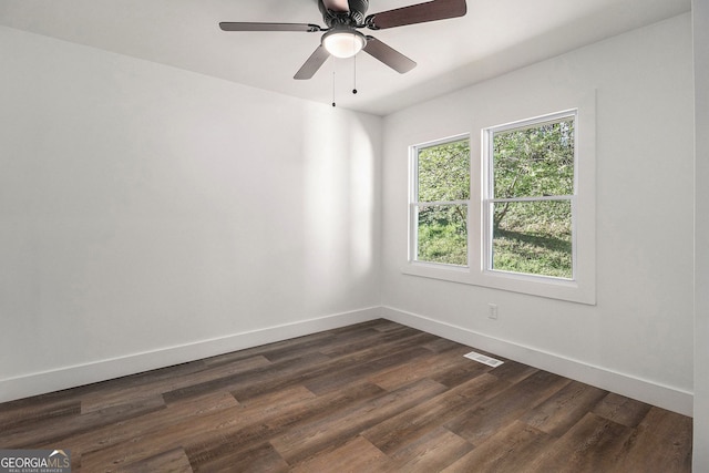 empty room featuring dark hardwood / wood-style floors and ceiling fan