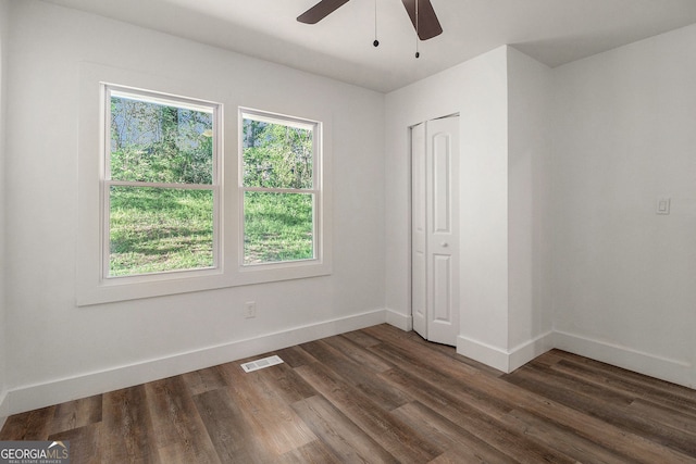 unfurnished room with ceiling fan and dark hardwood / wood-style floors