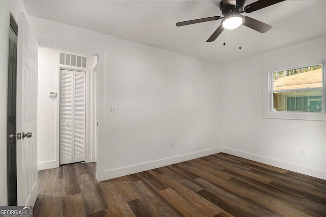 empty room featuring ceiling fan and dark wood-type flooring