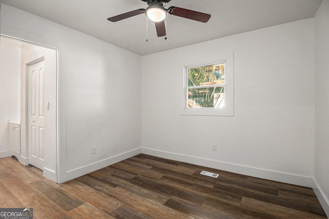 unfurnished room with dark hardwood / wood-style flooring and ceiling fan