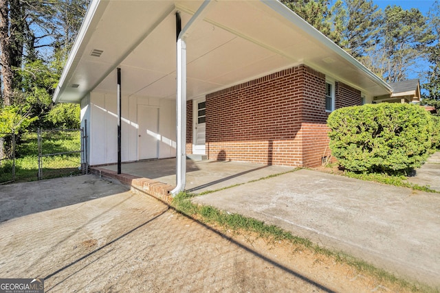 view of side of home with a carport