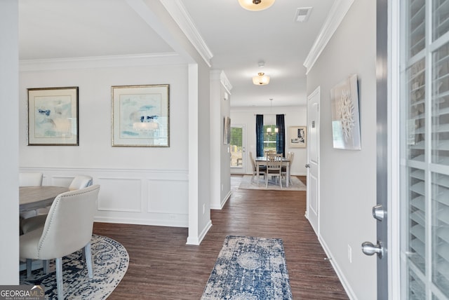 entryway with dark hardwood / wood-style flooring and crown molding