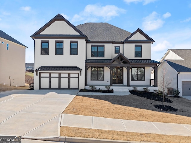 modern inspired farmhouse featuring driveway, a standing seam roof, metal roof, a shingled roof, and a garage