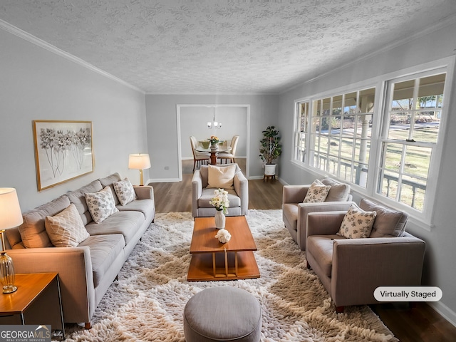 living room featuring a chandelier, hardwood / wood-style floors, a textured ceiling, and crown molding