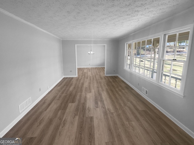 unfurnished room featuring dark hardwood / wood-style flooring, a chandelier, and a textured ceiling