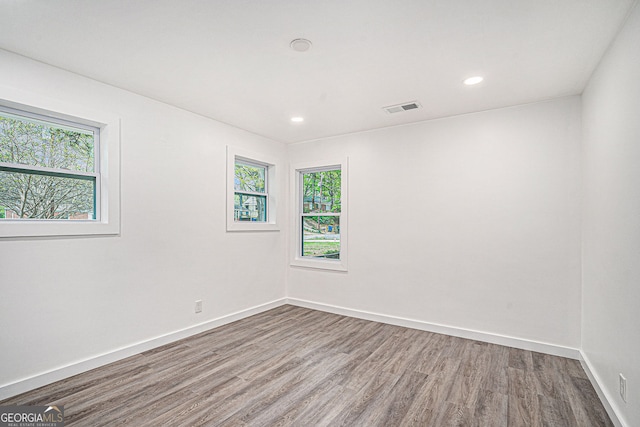 unfurnished room with wood-type flooring