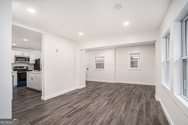 unfurnished living room featuring dark hardwood / wood-style floors