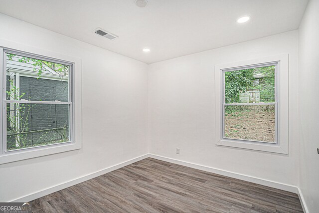 spare room with dark hardwood / wood-style floors