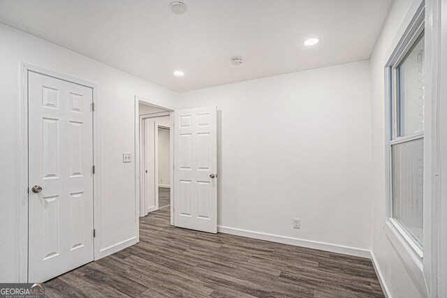 unfurnished bedroom with dark wood-type flooring