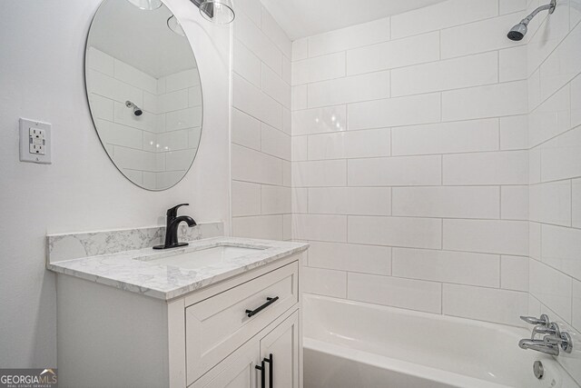 bathroom featuring vanity and tiled shower / bath combo