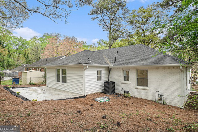 rear view of house featuring central AC and a patio area