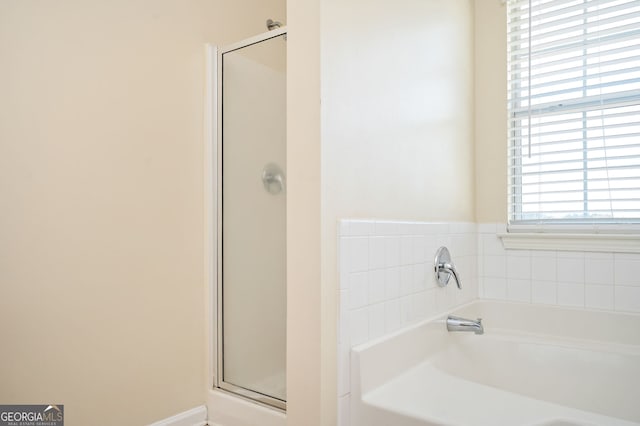 bathroom featuring plus walk in shower