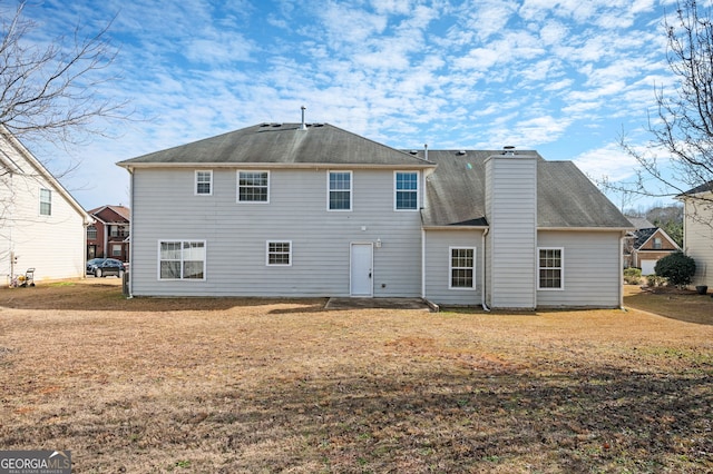 back of house featuring a yard