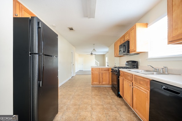 kitchen with kitchen peninsula, ceiling fan, sink, and black appliances