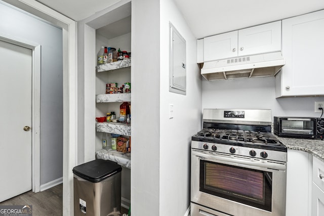 kitchen with light stone counters, gas stove, dark wood-type flooring, electric panel, and white cabinetry