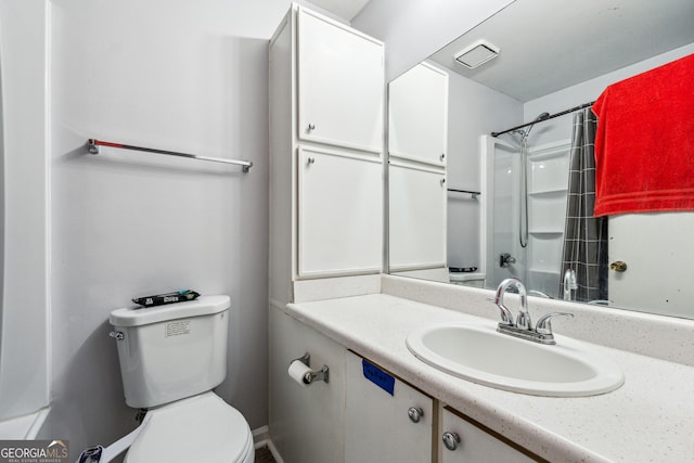 bathroom featuring a shower, vanity, and toilet