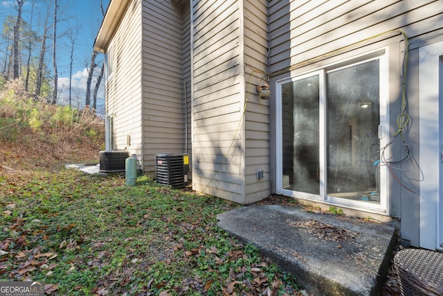 view of side of property featuring central AC