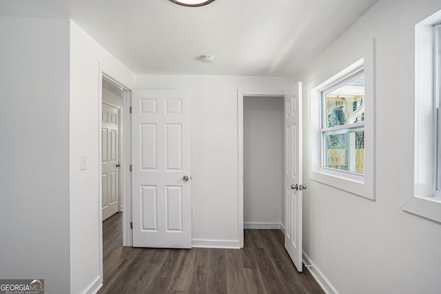 hall with dark hardwood / wood-style floors