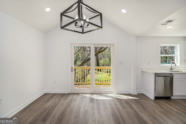 unfurnished dining area with vaulted ceiling, sink, a notable chandelier, and dark hardwood / wood-style flooring