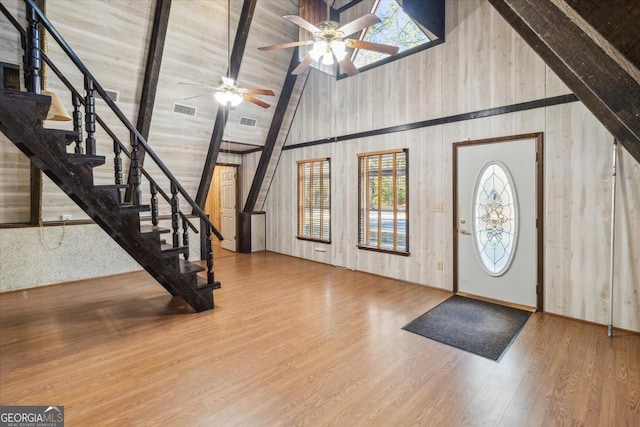 foyer featuring stairs, visible vents, and wood finished floors