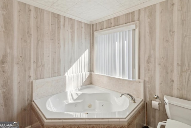 full bathroom with ornamental molding, toilet, and a tub with jets