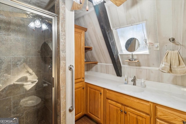 bathroom with a stall shower and vanity