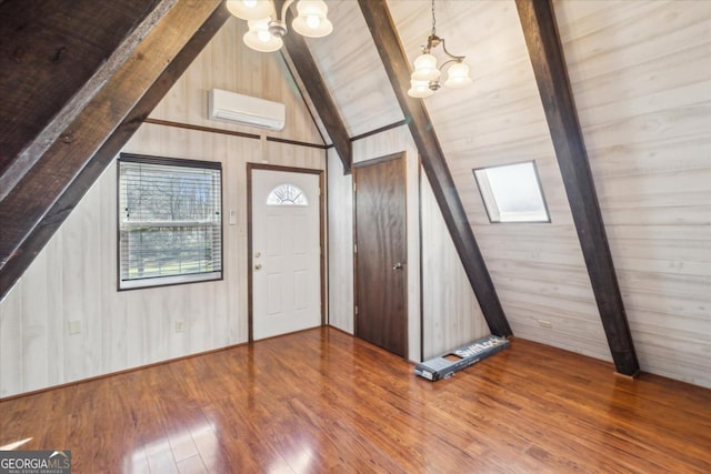 entryway featuring wooden walls, lofted ceiling with beams, hardwood / wood-style floors, a wall mounted air conditioner, and a notable chandelier