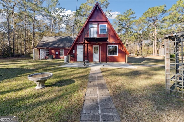 a-frame style home featuring a front yard and cooling unit