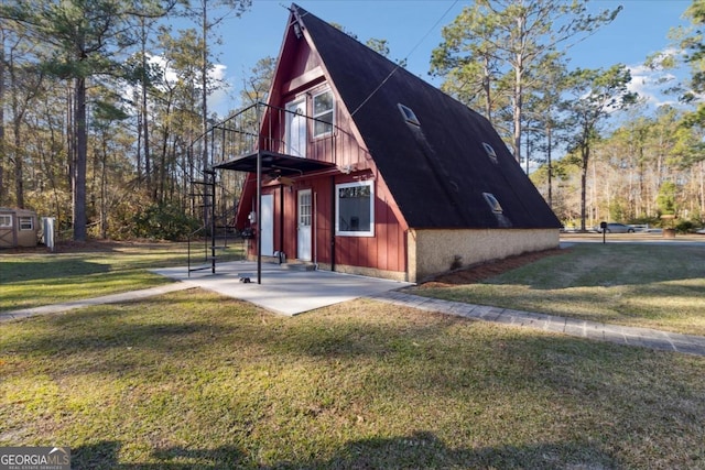 view of property exterior featuring an outdoor structure and a yard