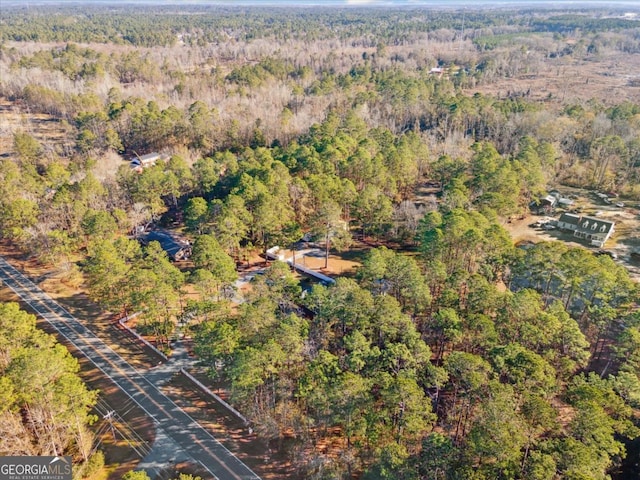 birds eye view of property with a forest view