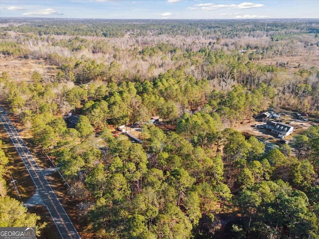 birds eye view of property with a forest view