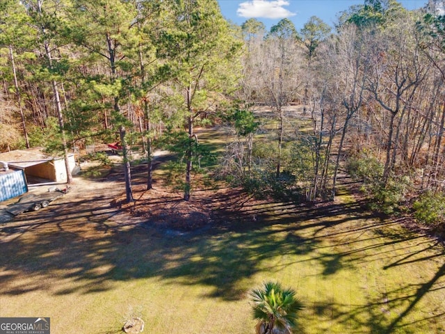 view of yard featuring a wooded view