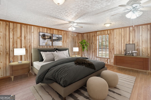 bedroom featuring ornamental molding, light wood-style flooring, and wooden walls