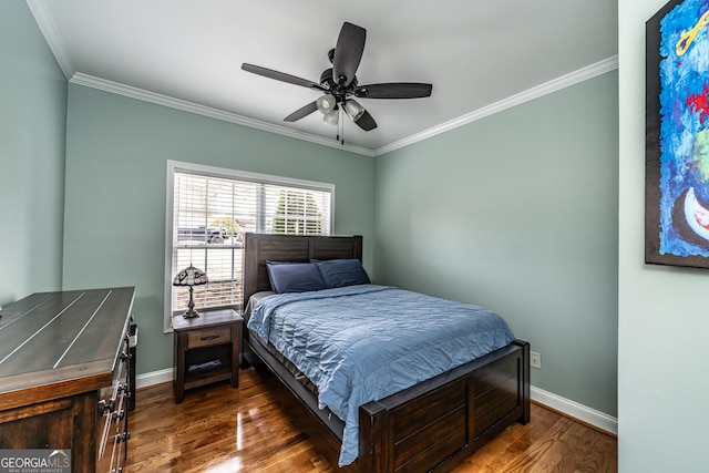 bedroom with dark hardwood / wood-style flooring, ceiling fan, and crown molding