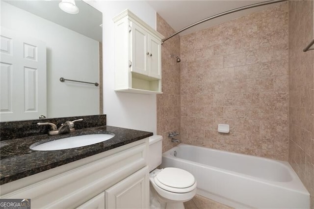 full bathroom with vanity, toilet, and tiled shower / bath