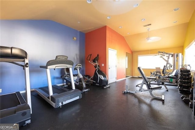 exercise room with vaulted ceiling